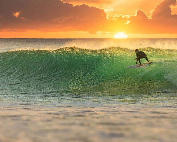 man surfing at sunset in Queensland