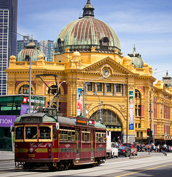 Flinders St Station in Melbourne with tram passing